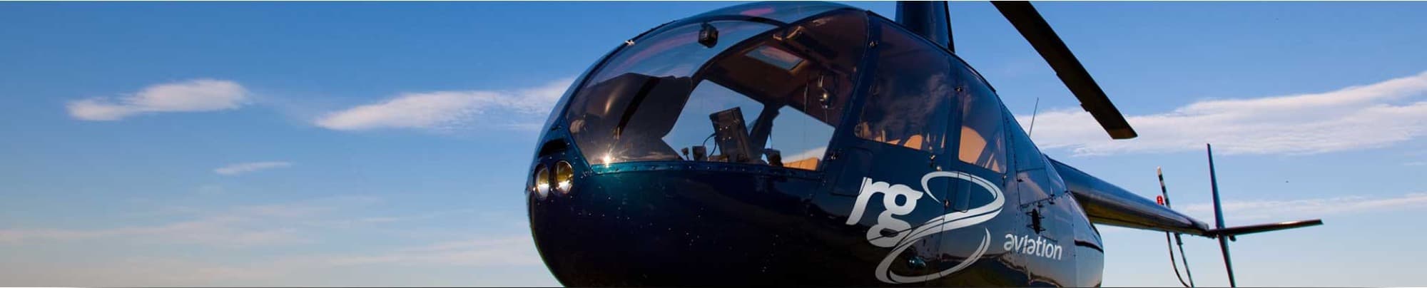 Helicóptero da RG8 Aviation sob céu azul, em foto publicada no site da empresa